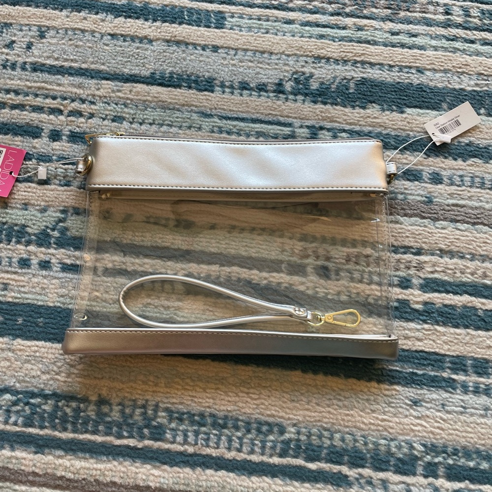NWT Clear/silver cross-body purse/wristlet bag. Measures: 11"W x 8"H